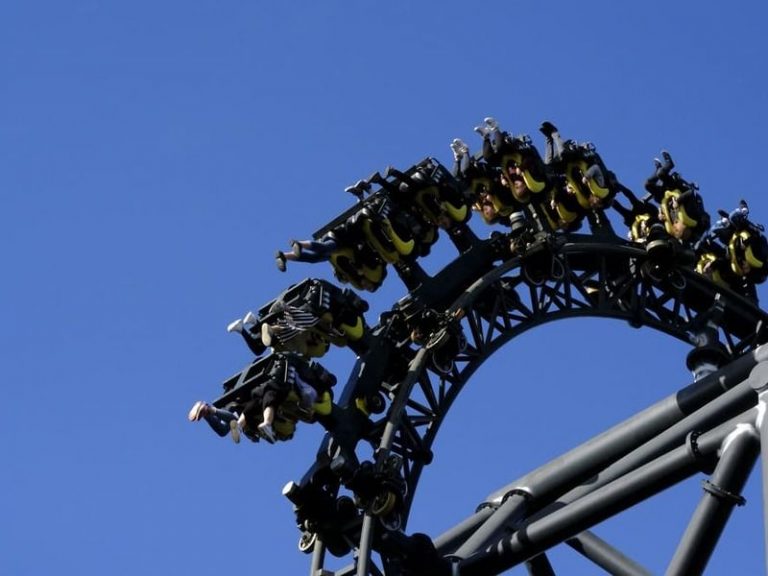 Montaña rusa Tornado del Parque de Atracciones de Madrid, con visitantes en plena curva a alta velocidad.